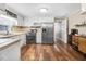 Well-equipped kitchen with stainless steel appliances, hardwood floors, and ample counter space at 2246 Arrowhead Rd, Dunn, NC 28334