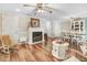 Spacious living room showcasing a fireplace, hardwood flooring, and abundant natural light at 2246 Arrowhead Rd, Dunn, NC 28334