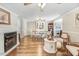 Open-concept living room with fireplace, hardwood floors, and elegant dining area at 2246 Arrowhead Rd, Dunn, NC 28334