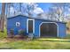 Charming blue shed with a black door, white trim, and decorated with a cardinal at 2246 Arrowhead Rd, Dunn, NC 28334