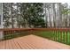Relaxing back deck with wood railings, overlooking a backyard with mature trees at 2301 Lemuel Dr, Raleigh, NC 27615