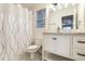Bright bathroom featuring a modern vanity, elegant fixtures, and a stylish shower curtain at 2301 Lemuel Dr, Raleigh, NC 27615