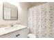 Well-lit bathroom featuring a modern vanity, updated fixtures, and decorative shower curtain at 2301 Lemuel Dr, Raleigh, NC 27615