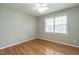 Well-lit bedroom with hardwood floors, a window, and neutral walls at 2301 Lemuel Dr, Raleigh, NC 27615