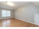 Sunlit bedroom with hardwood floors and neutral walls at 2301 Lemuel Dr, Raleigh, NC 27615
