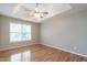 Spacious bedroom with tray ceiling, fan, and large window allowing ample natural light at 2301 Lemuel Dr, Raleigh, NC 27615