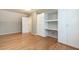Bright bedroom featuring hardwood floors and custom built-in shelving for ample storage at 2301 Lemuel Dr, Raleigh, NC 27615