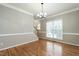 Spacious dining room with hardwood floors, neutral paint, and a staircase at 2301 Lemuel Dr, Raleigh, NC 27615