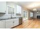 Bright kitchen featuring white cabinets, stainless steel appliances, and hardwood floors at 2301 Lemuel Dr, Raleigh, NC 27615
