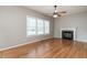 Inviting living room with hardwood floors, a fireplace with marble surround, and abundant natural light at 2301 Lemuel Dr, Raleigh, NC 27615