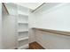 Walk-in closet with white shelving, ample storage space, and hardwood floors at 2301 Lemuel Dr, Raleigh, NC 27615