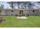 Spacious backyard featuring a grassy lawn, patio, and exterior of the home at 2312 Valley Rd, Sanford, NC 27330