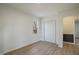 Bright bedroom featuring light-colored walls, light wood floors, and a closet at 2312 Valley Rd, Sanford, NC 27330