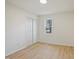 Bright bedroom with white closet, light-colored walls, and light wood floors at 2312 Valley Rd, Sanford, NC 27330