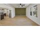 Open dining area with updated fixtures, a decorative green accent wall, and new flooring creating an airy atmosphere at 2312 Valley Rd, Sanford, NC 27330