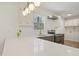 Well-lit kitchen featuring updated countertops, stainless steel appliances, and a modern lighting fixture at 2312 Valley Rd, Sanford, NC 27330