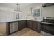 Updated kitchen featuring stainless appliances, white countertops, and modern lighting fixtures at 2312 Valley Rd, Sanford, NC 27330
