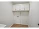Bright laundry room featuring white cabinets and modern fixtures, designed for functionality at 2312 Valley Rd, Sanford, NC 27330