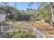 Expansive backyard with a fire pit, lush landscaping, and a wooded area at 2313 Prince St, Durham, NC 27707