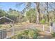 Backyard with a fire pit area, mature trees, and a storage shed at 2313 Prince St, Durham, NC 27707