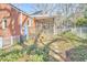 Backyard view featuring a screened porch, flower garden and a white fence at 2313 Prince St, Durham, NC 27707