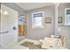 Bright bathroom featuring modern vanity, window, and walk-in shower with glass door at 2313 Prince St, Durham, NC 27707