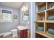 Stylish bathroom with modern vanity, built-in shelves, and wood-look floors at 2313 Prince St, Durham, NC 27707