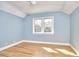 Cozy bedroom with hardwood floors and double windows providing ample light at 2313 Prince St, Durham, NC 27707