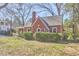 Charming brick home featuring mature landscaping and a chimney at 2313 Prince St, Durham, NC 27707