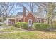 Charming brick home featuring a screened porch and mature landscaping at 2313 Prince St, Durham, NC 27707