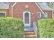 Close-up of the front door with a wreath and decorative window at 2313 Prince St, Durham, NC 27707