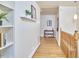 Bright hallway featuring hardwood floors, white walls, and natural light at 2313 Prince St, Durham, NC 27707