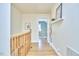 Hallway featuring hardwood floors, white walls, and a wood railing at 2313 Prince St, Durham, NC 27707