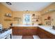 Sunlit kitchen showcases wooden cabinets, white countertops, and open shelving at 2313 Prince St, Durham, NC 27707
