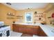 Bright kitchen featuring wooden cabinets, white countertops, and open shelving at 2313 Prince St, Durham, NC 27707