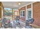 Relaxing screened porch with brick accents and outdoor seating at 2313 Prince St, Durham, NC 27707