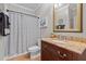 Cozy bathroom featuring a decorative shower curtain and a granite-topped vanity at 233 Candia Ln, Cary, NC 27519