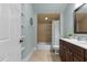 Bright bathroom featuring a tiled shower/tub combination, decorative shelves, and a modern vanity at 233 Candia Ln, Cary, NC 27519