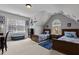 Bedroom boasts two twin beds, natural light from two windows, sports-themed decorations, and carpet flooring at 233 Candia Ln, Cary, NC 27519
