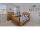 Bright bedroom with a wooden frame bed, dresser, and a window bringing in natural light at 233 Candia Ln, Cary, NC 27519