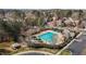 Aerial view of a pristine community pool surrounded by tables, chairs, and umbrellas at 233 Candia Ln, Cary, NC 27519