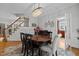 Elegant dining room with dark wood accents, traditional decor, a view of the staircase, and easy access to the kitchen at 233 Candia Ln, Cary, NC 27519