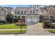 Charming two-story home with a two-car garage, landscaped yard, and covered porch at 233 Candia Ln, Cary, NC 27519