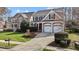 Charming two-story home with a two-car garage, landscaped yard, and inviting curb appeal at 233 Candia Ln, Cary, NC 27519