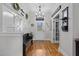 Inviting foyer with hardwood floors, decorative bench, and modern lighting fixtures at 233 Candia Ln, Cary, NC 27519