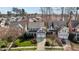 Aerial view of a beautiful two-story home with a well-manicured lawn, a two-car garage, and mature trees at 233 Candia Ln, Cary, NC 27519