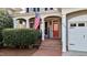 Inviting front porch featuring brick steps, white columns, and a vibrant red front door at 233 Candia Ln, Cary, NC 27519