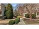 Charming home with a well-maintained front yard, walkway, and lush landscaping at 233 Candia Ln, Cary, NC 27519
