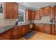 Well-appointed kitchen with granite counters, wood cabinets, and stainless steel dishwasher at 233 Candia Ln, Cary, NC 27519