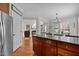 Open kitchen with a large island, wood cabinetry, and views to the living area at 233 Candia Ln, Cary, NC 27519